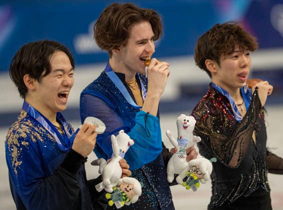 February 14, 2026, Milan, Lombardy, Italy: KazakhstanÃ¢â‚¬â ¢s MIKHAIL SHAIDOROV, JapanÃ¢â‚¬â ¢s SHUN SATO, right, and JapanÃ¢â‚¬â ¢s YUMA KAGIYAMA, LEFT, with country flag to with his Gold Medal after winning in menÃ¢â‚¬â ¢s Figure skating, Eiskunstlauf Friday at the Milano Ice Skating Arena during this Milano Cortina 2026 Olympics. Olympics 2026: Milano Cortina: Figure Skating Men s  - ZUMAa35_ 20260214_oly_a35_035 Copyright: xDanielxA.xAndersonx