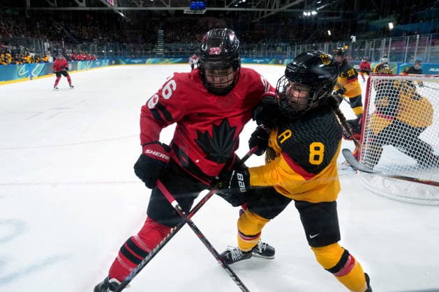 February 14, 2026, Milan, ITALY: Canada s Emily Clark (26) checks Germany s Ronja Hark (8) during the first period of a women s hockey quarterfinal game at the 2026 Winter Olympics, in Milan, Saturday, Feb. 14, 2026. Canada News - February 14, 2026  - ZUMAc35_ 20260214_zaf_c35_021 Copyright: xDarrylxDyckx
