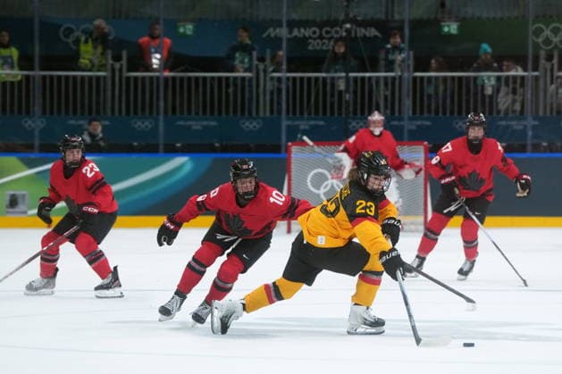 February 14, 2026, Milan, ITALY: Germany s Lilli Welcke (23) moves the puck past Canada s Sarah Fillier (10) during the first period of a women s hockey quarterfinal game at the 2026 Winter Olympics, in Milan, Saturday, Feb. 14, 2026. Canada News - February 14, 2026  - ZUMAc35_ 20260214_zaf_c35_028 Copyright: xDarrylxDyckx