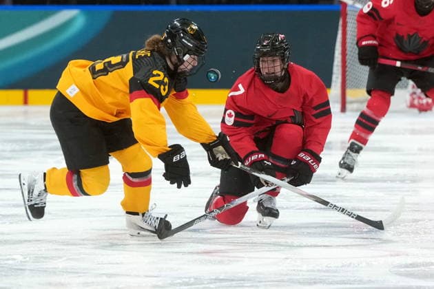 February 14, 2026, Milan, ITALY: Germany s Lilli Welcke (23) and Canada s Laura Stacey (7) vie for control of the puck during the second period of a women s hockey quarterfinal game at the 2026 Winter Olympics, in Milan, Saturday, Feb. 14, 2026. Canada News - February 14, 2026  - ZUMAc35_ 20260214_zaf_c35_031 Copyright: xDarrylxDyckx