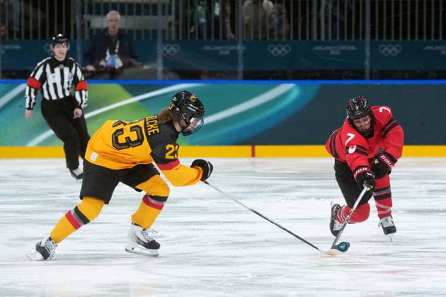 February 14, 2026, Milan, ITALY: Canada s Laura Stacey (7) and Germany s Lilli Welcke (23) vie for control of the puck during the second period of a women s hockey quarterfinal game at the 2026 Winter Olympics, in Milan, Saturday, Feb. 14, 2026. Canada News - February 14, 2026  - ZUMAc35_ 20260214_zaf_c35_034 Copyright: xDarrylxDyckx