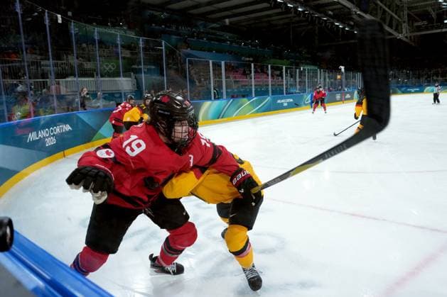 February 14, 2026, Milan, ITALY: Canada s Brianne Jenner (19) gets checked by Germany s Ronja Hark (8) during the second period of a women s hockey quarterfinal game at the 2026 Winter Olympics, in Milan, Saturday, Feb. 14, 2026. Canada News - February 14, 2026  - ZUMAc35_ 20260214_zaf_c35_040 Copyright: xDarrylxDyckx