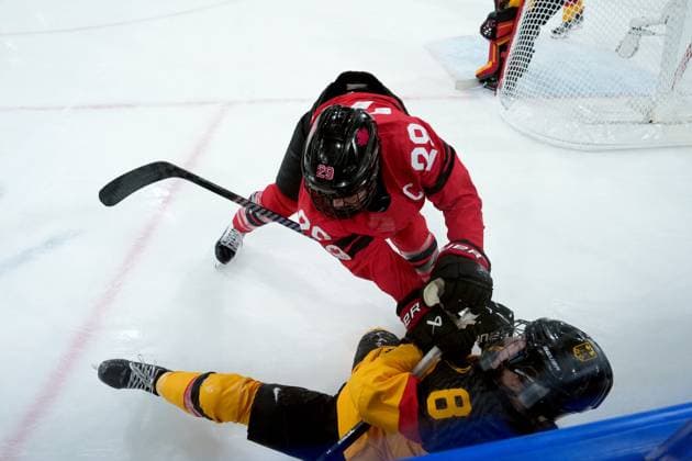 February 14, 2026, Milan, ITALY: Canada s Marie-Philip Poulin (29) checks Germany s Ronja Hark (8) during the second period of a women s hockey quarterfinal game at the 2026 Winter Olympics, in Milan, Saturday, Feb. 14, 2026. Canada News - February 14, 2026  - ZUMAc35_ 20260214_zaf_c35_042 Copyright: xDarrylxDyckx