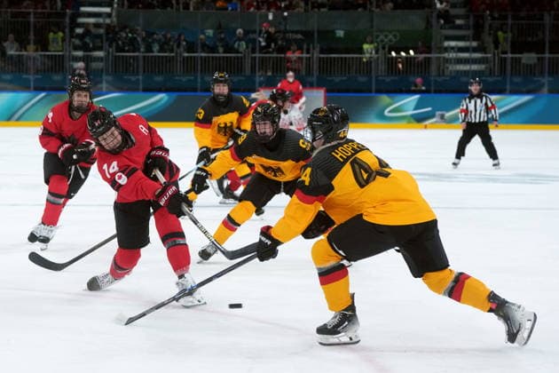 February 14, 2026, Milan, ITALY: Canada s Renata Fast (14) takes a shot on goal past Germany s Hanna Hoppe (44) during the second period of a women s hockey quarterfinal game at the 2026 Winter Olympics, in Milan, Saturday, Feb. 14, 2026. Canada News - February 14, 2026  - ZUMAc35_ 20260214_zaf_c35_060 Copyright: xDarrylxDyckx