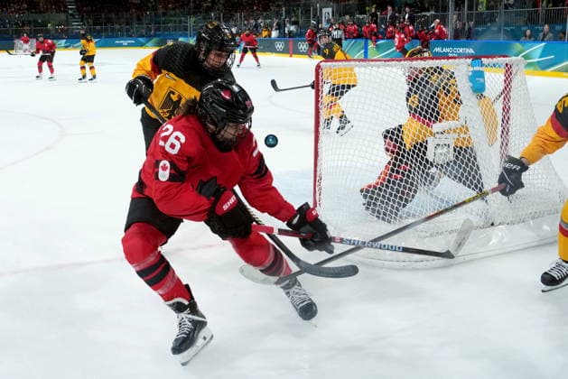 February 14, 2026, Milan, ITALY: Canada s Emily Clark (26) vies for control of the puck with Germany s Charlott Schaffrath (5) during the second period of a women s hockey quarterfinal game at the 2026 Winter Olympics, in Milan, Saturday, Feb. 14, 2026. Canada News - February 14, 2026  - ZUMAc35_ 20260214_zaf_c35_062 Copyright: xDarrylxDyckx
