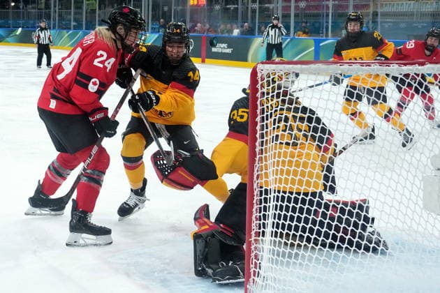 February 14, 2026, Milan, ITALY: Germany s Carina Strobel checks Canada s Natalie Spooner (24) after she got stopped by Germany goalie Sandra Abstreiter (35) during the third period of a women s hockey quarterfinal game at the 2026 Winter Olympics, in Milan, Saturday, Feb. 14, 2026. Canada News - February 14, 2026  - ZUMAc35_ 20260214_zaf_c35_066 Copyright: xDarrylxDyckx