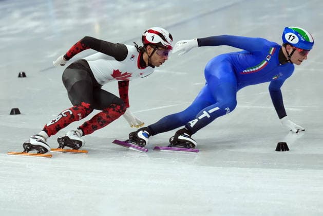 February 14, 2026, Milan, ITALY: Canada s William Dandjinou and Italy s Luca Spechenhauser compete in the Men s 1500m Short Track Speed skating, Eisschnelllauf event during the 2026 Milan Cortina Winter Olympics in Milan, Italy on Saturday, February 14, 2026. Canada News - February 14, 2026  - ZUMAc35_ 20260214_zaf_c35_116 Copyright: xNathanxDenettex