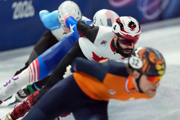 February 14, 2026, Milan, ITALY: Canada s Steven Dubios (4) competes in the Men s quarterfinal 1500m Short Track Speed skating, Eisschnelllauf event during the 2026 Milan Cortina Winter Olympics in Milan, Italy on Saturday, February 14, 2026. Canada News - February 14, 2026  - ZUMAc35_ 20260214_zaf_c35_142 Copyright: xNathanxDenettex