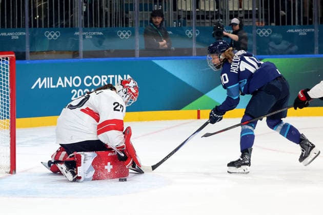 February 14, 2026, Milan, Lombardy, Italy: Andrea Braendli 20 of Team Switzerland deflects shot by Elisa Holopainen 10 of Team Finland in a women s Ice hockey, Eishockey quarterfinal during the Milano Cortina 2026 Olympic Winter games, Winterspiele,Spiele, Summer games at Milano Rho Ice Hockey Arena. Olympics 2026: Milano Cortina: Ice Hockey-Women Quarterfinal - FIN-SUI  - ZUMAm117 20260214_oly_m117_008 Copyright: xDavidxMcIntyrex