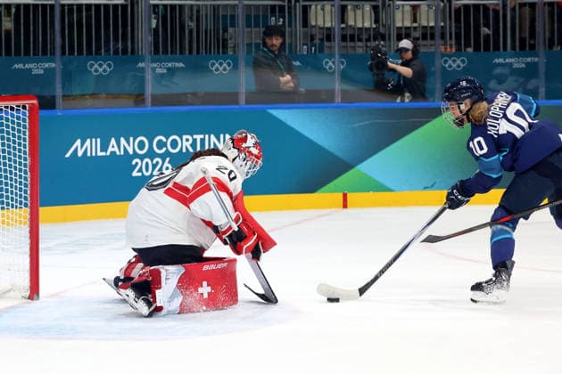 February 14, 2026, Milan, Lombardy, Italy: Andrea Braendli 20 of Team Switzerland deflects shot by Elisa Holopainen 10 of Team Finland in a women s Ice hockey, Eishockey quarterfinal during the Milano Cortina 2026 Olympic Winter games, Winterspiele,Spiele, Summer games at Milano Rho Ice Hockey Arena. Olympics 2026: Milano Cortina: Ice Hockey-Women Quarterfinal - FIN-SUI  - ZUMAm117 20260214_oly_m117_007 Copyright: xDavidxMcIntyrex