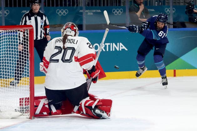 February 14, 2026, Milan, Lombardy, Italy: Emma Nuutinen 61 of Team Finland shoots towards goalie Andrea Braendli 20 of Team Switzerland in a women s Ice hockey, Eishockey quarterfinal during the Milano Cortina 2026 Olympic Winter games, Winterspiele,Spiele, Summer games at Milano Rho Ice Hockey Arena. Olympics 2026: Milano Cortina: Ice Hockey-Women Quarterfinal - FIN-SUI  - ZUMAm117 20260214_oly_m117_009 Copyright: xDavidxMcIntyrex
