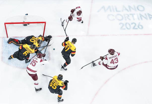 (260215) -- MILAN, Feb. 15, 2026 -- Martins Dzierkals (top) of Latvia competes during the Ice hockey, Eishockey men s preliminary round group C match between Germany and Latvia of the Milan-Cortina 2026 Olympic Winter games, Winterspiele,Spiele, Summer games in Milan, Italy, Feb. 14, 2026. ) (MICO2026)ITALY-MILAN-OLYMPIC WINTER GAMES-ICE HOCKEY-MEN-PRELIMINARY-GER VS LAT SunxFei 