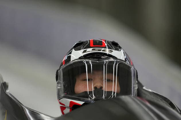 (260215) -- CORTINA D AMPEZZO, Feb. 15, 2026 -- Huai Mingming of China competes during the bobsleigh women s monobob heat at the 2026 Milan-Cortina Winter Olympics in Cortina, Italy, Feb. 15, 2026. ) (MICO2026)ITALY-CORTINA D AMPEZZO-OLYMPIC Winter games, Winterspiele,Spiele, Summer games BOBSLEIGH-WOMEN S MONOBOB-HEAT LixGang 