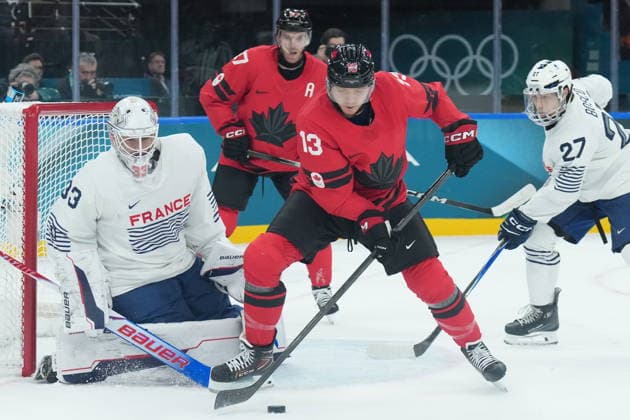 February 15, 2026, Milan, ITALY: Julian Junca (33) of Team France makes a save on Sam Reinhart (13) of Team Canada during first period Olympic hockey action at the 2026 Milan Cortina Winter Olympics in Milan, Italy on Sunday Feb. 15, 2026. Canada News - February 15, 2026  - ZUMAc35_ 20260215_zaf_c35_067 Copyright: xNathanxDenettex