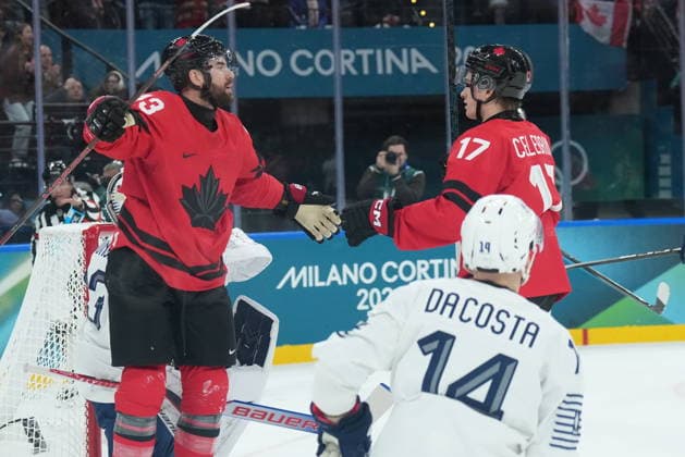 February 15, 2026, Milan, ITALY: Tom Wilson (43) of Team Canada celebrates his goal with teammate Macklin Celebrini (17) as Stephane da Costa (14) of Team France looks on during first period Olympic hockey action at the 2026 Milan Cortina Winter Olympics in Milan, Italy on Sunday Feb. 15, 2026. Canada News - February 15, 2026  - ZUMAc35_ 20260215_zaf_c35_069 Copyright: xNathanxDenettex