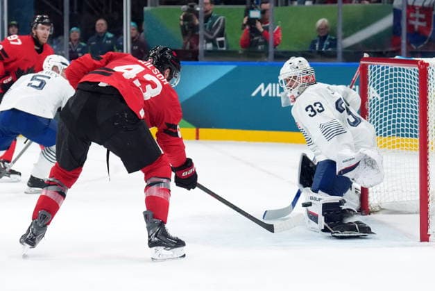 February 15, 2026, Milan, ITALY: Julian Junca (33) of Team France makes a save on Tom Wilson (43) of Team Canada during second period Olympic hockey action at the 2026 Milan Cortina Winter Olympics in Milan, Italy on Sunday, February 15, 2026. Canada News - February 15, 2026  - ZUMAc35_ 20260215_zaf_c35_094 Copyright: xNathanxDenettex