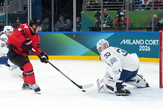 February 15, 2026, Milan, ITALY: Bo Horvat (14) of Team Canada is stopped by Julian Junca (33) of Team France during second period Olympic hockey action at the 2026 Milan Cortina Winter Olympics in Milan, Italy on Sunday, February 15, 2026. Canada News - February 15, 2026  - ZUMAc35_ 20260215_zaf_c35_096 Copyright: xNathanxDenettex