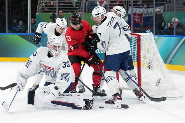 February 15, 2026, Milan, ITALY: Sam Reinhart (13) of Team Canada is stopped by Julian Junca (33) of Team France as Pierre Crinon (7) Florian Chakiachvili (62) and Justin Addamo (24) defend during second period Olympic hockey action at the 2026 Milan Cortina Winter Olympics in Milan, Italy on Sunday, February 15, 2026. Canada News - February 15, 2026  - ZUMAc35_ 20260215_zaf_c35_097 Copyright: xNathanxDenettex