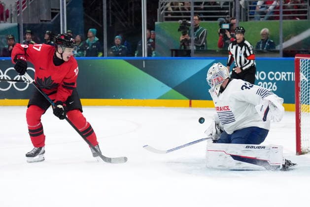 February 15, 2026, Milan, ITALY: Macklin Celebrini (17) of Team Canada is stopped by Julian Junca (33) of Team France during second period Olympic hockey action at the 2026 Milan Cortina Winter Olympics in Milan, Italy on Sunday, February 15, 2026. Canada News - February 15, 2026  - ZUMAc35_ 20260215_zaf_c35_099 Copyright: xNathanxDenettex