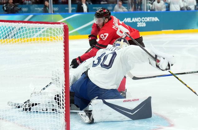 February 15, 2026, Milan, ITALY: Connor McDavid (97) of Team Canada scores on goalie Antoine Keller (30) of Team France during third period Olympic hockey action at the 2026 Milan Cortina Winter Olympics in Milan, Italy on Sunday, February 15, 2026. Canada News - February 15, 2026  - ZUMAc35_ 20260215_zaf_c35_104 Copyright: xNathanxDenettex
