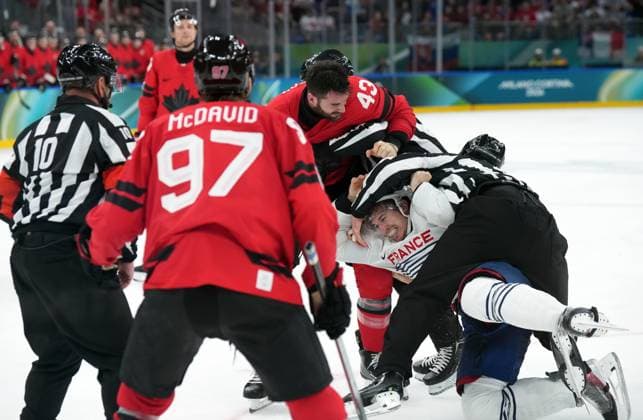 February 15, 2026, Milan, ITALY: Tom Wilson (43) of Team Canada fights with Pierre Crinon (7) of Team France during third period Olympic hockey action at the 2026 Milan Cortina Winter Olympics in Milan, Italy on Sunday, February 15, 2026. Canada News - February 15, 2026  - ZUMAc35_ 20260215_zaf_c35_110 Copyright: xNathanxDenettex