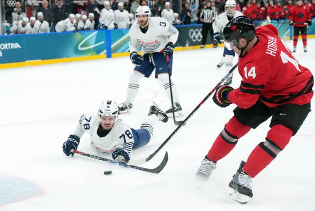 February 15, 2026, Milan, ITALY: Bo Horvat (14) of Team Canada and Dylan Fabre (78) of Team France battle for the puck during third period Olympic hockey action at the 2026 Milan Cortina Winter Olympics in Milan, Italy on Sunday, February 15, 2026. Canada News - February 15, 2026  - ZUMAc35_ 20260215_zaf_c35_114 Copyright: xNathanxDenettex