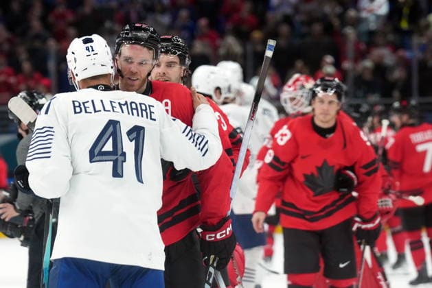 February 15, 2026, Milan, ITALY: Connor McDavid (97) of Team Canada shakes hands with Pierre-Edouard Bellemare (41) of Team France Olympic hockey action at the 2026 Milan Cortina Winter Olympics in Milan, Italy on Sunday, February 15, 2026. Canada News - February 15, 2026  - ZUMAc35_ 20260215_zaf_c35_119 Copyright: xNathanxDenettex