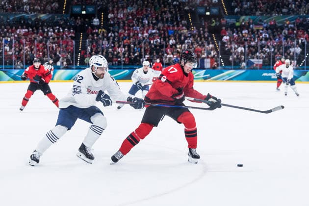 MILANO, ITALY - FEBRUARY 15: Florian Chakiachvili (France, 62) and Macklin Celebrini (Canada, 17) fight for the puck during the Ice hockey, Eishockey Men Canada vs France - Preliminary Round - Group A at the Milano Cortina 2026 Olympics at Milano Santagiulia Ice Hockey Arena on day 9 of the Milano Cortina 2026 Olympics on February 15, 2026 in Milano, Italy. Editorial use only. Italy Copyright: xSteffiexWunderlx