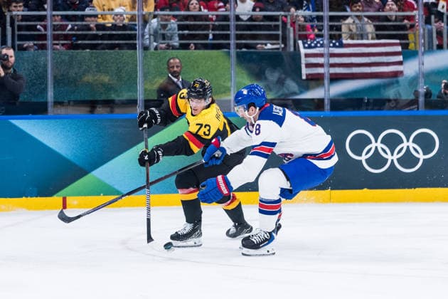 MILANO, ITALY - FEBRUARY 15: Lukas Reichel (Germany, 73) controls the puck against Zach Werenski (United States of America, 8) during the Ice hockey, Eishockey Men United States of America vs Germany - Preliminary Round - Group C at the Milano Cortina 2026 Olympics at Milano Santagiulia Ice Hockey Arena on day 9 of the Milano Cortina 2026 Olympics on February 15, 2026 in Milano, Italy. Editorial use only. Italy Copyright: xSteffiexWunderlx