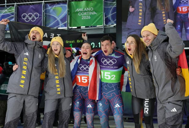 (260215) -- CORTINA D AMPEZZO, Feb. 15, 2026 -- Gold medalists Tabitha Stoecker Matt Weston of Britain, silver medalists Susanne Kreher Axel Jungk of Germany and bronze medalists Jacqueline Pfeifer Christopher Grotheer of Germany celebrate after the skeleton mixed team competition at the Milan-Cortina 2026 Olympic Winter games, Winterspiele,Spiele, Summer games in Cortina, Italy, Feb. 15, 2026. ) (MICO2026)ITALY-CORTINA D AMPEZZO-OLYMPIC WINTER GAMES-SKELETON MIXED TEAM DingxXu 