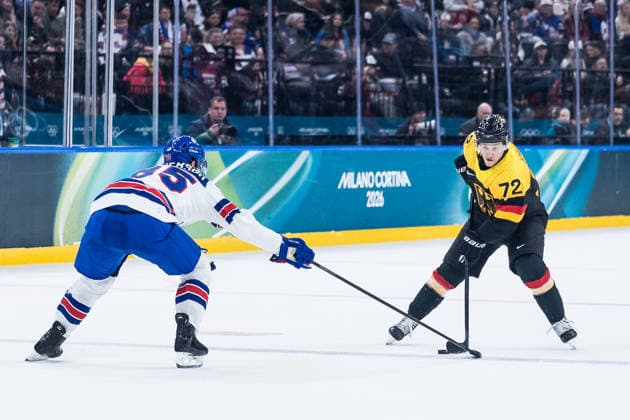 MILANO, ITALY - FEBRUARY 15: Dominik Kahun (Germany, 72) controls the puck against Jake Sanderson (United States of America, 85) during the Ice hockey, Eishockey Men United States of America vs Germany - Preliminary Round - Group C at the Milano Cortina 2026 Olympics at Milano Santagiulia Ice Hockey Arena on day 9 of the Milano Cortina 2026 Olympics on February 15, 2026 in Milano, Italy. Editorial use only. Italy Copyright: xSteffiexWunderlx