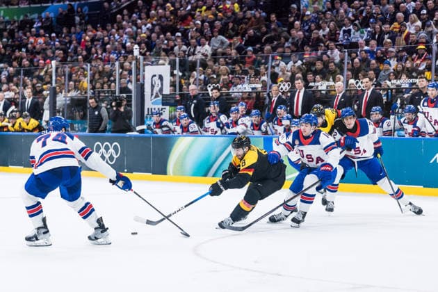 MILANO, ITALY - FEBRUARY 15: Tobias Rieder (Germany, 8) fights for the puck against Jaccob Slavin (United States of America, 74) and Brock Faber (United States of America, 14) during the Ice hockey, Eishockey Men United States of America vs Germany - Preliminary Round - Group C at the Milano Cortina 2026 Olympics at Milano Santagiulia Ice Hockey Arena on day 9 of the Milano Cortina 2026 Olympics on February 15, 2026 in Milano, Italy. Editorial use only. Italy Copyright: xSteffiexWunderlx