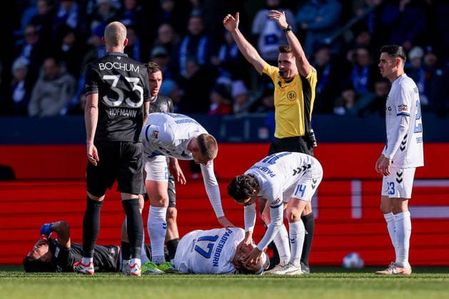 15 02 2026, Football, VfL Bochum SC Paderborn 07, 2 Fußball Bundesliga, 22 Matchday, Vonovia Ruhrstadion, Season 2025 2026 Laurin Curda SC Paderborn 17 lies injured on the ground next to Steffen Tigges SC Paderborn 27 Mika Baur SC Paderborn 14 Raphael Obermair SC Paderborn 23 DFB regulations prohibit any use of photographs as image sequences and or quasi video Nordrhein Westfalen Germany