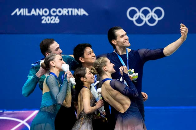 (L-R) Anastasiia Metelkina and Luka Berulava of Georgia, Wenjing Sui and Cong Han of China and Minerva Fabienne Hase and Nikita Volodin of Germany take a selfie during the medal ceremony after the Pair Skating Free Skating Final at the Milano Figure skating, Eiskunstlauf Arena in Milan, Italy on Monday, February 16, 2026. Wenjing Sui and Cong Han of China won gold, Anastasiia Metelkina and Luka Berulava of Georgia won silver and Minerva Fabienne Hase and Nikita Volodin of Germany won bronze.  OLY20260216969 RICHARDxELLIS