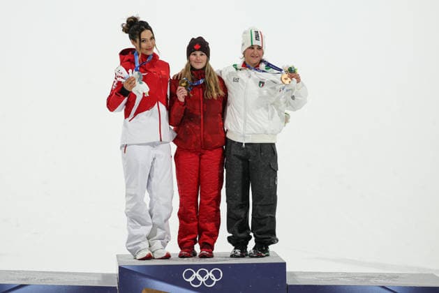 LIVIGNO, ITALY - FEBRUARY 16: Gold medalist Megan Oldham (C) of Team Canada celebrates on the podium with silver medalist Eileen Gu Ailing (L) of Team China and bronze medalist Flora Tabanelli of Team Italy during the medal ceremony for the Women s Freeski Big Air Final on day ten of the Milano Cortina 2026 Winter Olympic Games, Olympische Spiele, Olympia, OS at Livigno Snow Park on February 16, 2026 in Livigno, Italy.  Copyright: xCHINASPORTSx 111621938944