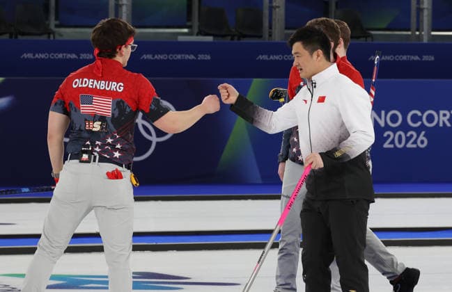 USA s Aidan Oldenburg fist pumps China s Xu Xiaoming after losing their match against China in the Round Robin Team Curling match at the 2026 Winter Olympics in Cortina, Italy on Tuesday February 17, 2026. China won the match 8-5.  OLY20260217655 HUGOxPHILPOTT