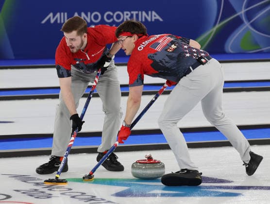 USA s Ben Richardson (L) and Aidan Oldenburg polish the ice in their match against China in the Round Robin Team Curling match at the 2026 Winter Olympics in Cortina, Italy on Tuesday February 17, 2026. China won the match 8-5.  OLY20260217603 HUGOxPHILPOTT
