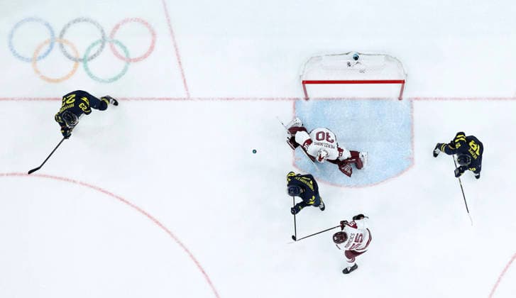 260217 -- MILAN, Feb. 17, 2026 -- Elvis Merzlikins 3rd R of Latvia defends during the Ice hockey, Eishockey men s qualification play-off match between the Sweden and Latvia at the Milan-Cortina 2026 Olympic Winter games, Winterspiele,Spiele, Summer games in Milan, Italy, Feb. 17, 2026. MICO2026ITALY-MILAN-OLYMPIC WINTER GAMES-ICE HOCKEY-MEN-QUALIFICATION PLAY-OFF-SWE VS LAT ZhangxHaofu  (MICO2026)ITALY-MILAN-OLYMPIC WINTER GAMES-ICE HOCKEY-MEN-QUALIFICATION PLAY-OFF-SWE VS LAT IMAGO ZhangxHaofu  imago images 0847879260