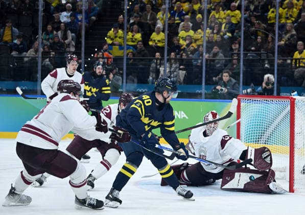 260217 -- MILAN, Feb. 17, 2026 -- Elias Pettersson 2nd R of Sweden shoots during the Ice hockey, Eishockey men s qualification play-off match between the Sweden and Latvia at the Milan-Cortina 2026 Olympic Winter games, Winterspiele,Spiele, Summer games in Milan, Italy, Feb. 17, 2026. MICO2026ITALY-MILAN-OLYMPIC WINTER GAMES-ICE HOCKEY-MEN-QUALIFICATION PLAY-OFF-SWE VS LAT ZhangxHaofu  (MICO2026)ITALY-MILAN-OLYMPIC WINTER GAMES-ICE HOCKEY-MEN-QUALIFICATION PLAY-OFF-SWE VS LAT IMAGO ZhangxHaofu  imago images 0847879262