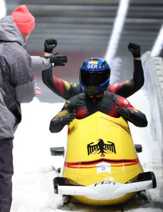 (260218) -- CORTINA D AMPEZZO, Feb. 18, 2026 -- Adam Ammour (front) Alexander Schaller of Germany celebrate after the Bobsleigh 2-man heat 4 at the Milan-Cortina 2026 Olympic Winter games, Winterspiele,Spiele, Summer games in Cortina D Ampezzo, Italy, Feb. 17, 2026. ) (MICO2026)ITALY-CORTINA D AMPEZZO-OLYMPIC WINTER GAMES-BOBSLEIGH-2-MAN DingxXu 