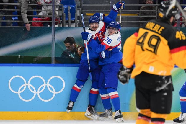 XXV Winter Olympic Games, Olympische Spiele, Olympia, OS in Milan, Italy, on February 18, 2026. Men s Ice hockey, Eishockey preliminary round playoffs, Slovakia - Germany. Milos Kelemen of Slovakia, left, celebrates a goal with his teammate Martin Pospisil. At right Lukas Kalble of Germany. (CTKxPhoto MichalxKamaryt) CTKPhotoP2026021804695  CTKPhotoP2026021804695