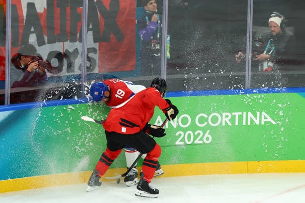 February 18, 2026, Milan, Lombardy, Italy: DEVON TOEWS 7 of Canada and JAKUB FLEK 19 of Czechia fight for the puck during the Quarterfinal game between Team Canada (CAN) and Team Czechia (CZE) at the Milano Cortina 2026 Olympic Games, Olympische Spiele, Olympia, OS Milan Italy - ZUMAc179 20260218_oly_c179_044 Copyright: xMickaelxChavetx
