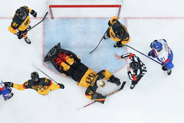 (260218) -- MILAN, Feb. 18, 2026 -- Goalkeeper Philipp Grubauer (C) of Germany saves the puck during the Ice hockey, Eishockey men s play-offs quarterfinal between the Slovakia and Germany at the Milan-Cortina 2026 Olympic Winter games, Winterspiele,Spiele, Summer games in Milan, Italy, Feb. 18, 2026. ) (MICO2026)ITALY-MILAN-OLYMPIC WINTER GAMES-ICE HOCKEY-MEN-PLAY-OFFS QUARTERFINALS-SVK VS GER WangxKaiyan 