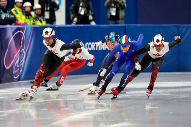Pietro Sighel, 3, of Italy and Maxime Laoun, 39, of Canada collide as William Dandjinou, 1, of Canada holds the lead during the Men s Short Track Speed skating, Eisschnelllauf 500m Semifinals at the Milano Figure skating, Eiskunstlauf Arena in Milan, Italy on Wednesday, February 18, 2026.  OLY20260218109 RICHARDxELLIS