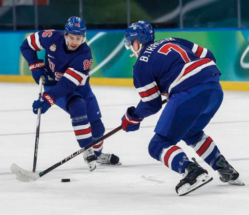 United States Jack Hughes (86) and United States Brady Tkachuk (7) go for the puck in the first period of the Men s Hockey Playoff Quarter-final game between Sweden and the USA at the Milano Santagiulia Ice hockey, Eishockey Arena in Milan, Italy, on Wednesday, February 18, 2026.  OLY20260218318 AARONxJOSEFCZYK