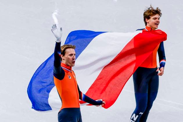 third Jens van t Wout of the Netherlands and second Melle van t Wout of the Netherlands celebrating and holding flag after Men s 500m Finals, Milano Cortina 2026 Winter Olympics: Day 12, Short Track Speed skating, Eisschnelllauf - Milano Cortina 2026 Winter Olympics: Day 12, Milano Speed Skating Stadium, February 18, 2026, Milan, Italy.