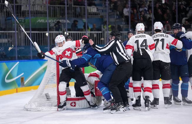(260219) -- MILAN, Feb. 19, 2026 -- Players of both teams fight during the Ice hockey, Eishockey men s play-offs quarterfinal between Finland and Switzerland at the Milan-Cortina 2026 Olympic Winter games, Winterspiele,Spiele, Summer games in Milan, Italy, Feb. 18, 2026. ) (MICO2026)ITALY-MILAN-OLYMPIC WINTER GAMES-ICE HOCKEY-MEN-PLAY-OFFS QUARTERFINALS-FIN VS SUI TaoxXiyi 
