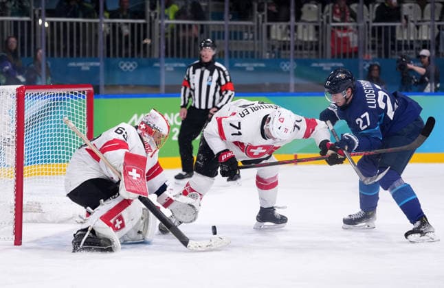 (260219) -- MILAN, Feb. 19, 2026 -- Switzerland s Leonardo Genoni (L) makes a save during the Ice hockey, Eishockey men s play-offs quarterfinal between Finland and Switzerland at the Milan-Cortina 2026 Olympic Winter games, Winterspiele,Spiele, Summer games in Milan, Italy, Feb. 18, 2026. ) (MICO2026)ITALY-MILAN-OLYMPIC WINTER GAMES-ICE HOCKEY-MEN-PLAY-OFFS QUARTERFINALS-FIN VS SUI TaoxXiyi 