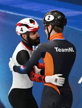 (260219) -- MILAN, Feb. 19, 2026 -- Steven Dubois (L) of Canada greets Jens van t Wout of the Netherlands after the short track Speed skating, Eisschnelllauf men s 500m final A at the Milan-Cortina 2026 Olympic Winter games, Winterspiele,Spiele, Summer games in Milan, Italy, Feb. 18, 2026. ) (MICO2026)ITALY-MILAN-OLYMPIC WINTER GAMES-SHORT TRACK SPEED SKATING-MEN S 500M-FINALS ChengxMin 