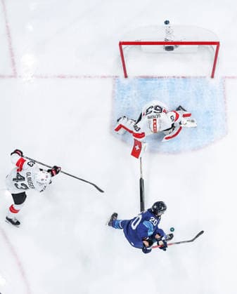 (260219) -- MILAN, Feb. 19, 2026 -- Sebastian Aho (bottom) of Finland shoots during the Ice hockey, Eishockey men s play-offs quarterfinal between Finland and Switzerland at the Milan-Cortina 2026 Olympic Winter games, Winterspiele,Spiele, Summer games in Milan, Italy, Feb. 18, 2026. ) (MICO2026)ITALY-MILAN-OLYMPIC WINTER GAMES-ICE HOCKEY-MEN-PLAY-OFFS QUARTERFINALS-FIN VS SUI SunxFei 